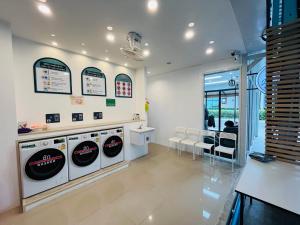 奈揚海灘的住宿－Jhen House，洗衣房配有3台洗衣机和1个柜台