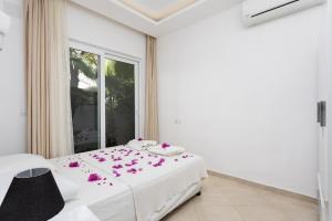a bedroom with a bed with pink flowers on it at Villa Casa Mia in Dalyan +35 photos