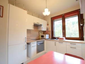 a kitchen with white cabinets and a window at Charmant appartement proche du lac avec Wi-Fi et parking à Évian-les-Bains - FR-1-498-96 in Évian-les-Bains