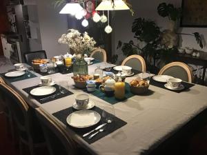 a table with plates and bowls of food on it at une maison à la campagne in Beaune-la-Rolande