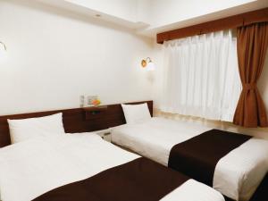 Giường trong phòng chung tại Hotel Check In Shimbashi