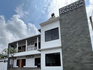 a white building with a koya sign on it at Kaira Room Guest House Syariah Redpartner in Yogyakarta