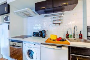 a kitchen with a washing machine and a sink at Studio De La Marmotte - Happy Rentals in Chamonix-Mont-Blanc