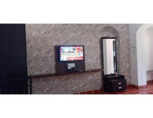 a living room with a television and a mirror at Shubham Resorts, Solapur in Solapur