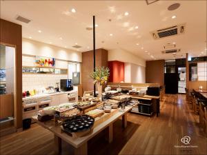 a kitchen with a table with food on it at Daiwa Roynet Hotel Takamatsu in Takamatsu