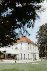 a white building with a red roof at Séquoias Golf & Ressort in Ruy
