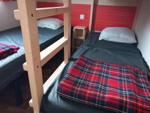 a bedroom with two bunk beds in a room at 431 Emplacement confort aux Fontaines 3 étoiles - 5 personnes in Ivry-la-Bataille +9 photos