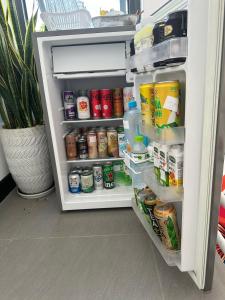 an open refrigerator full of food and drinks at Koi Guest House - Phan Thiết in Ấp Thiện Phước