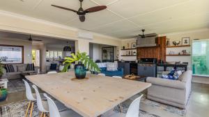 a kitchen and living room with a wooden table at 17 Malibu, Beverly Hills Estate in Ballito