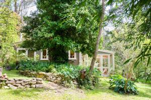 una piccola casa in mezzo a un cortile di Ashwood Cottages a Bright