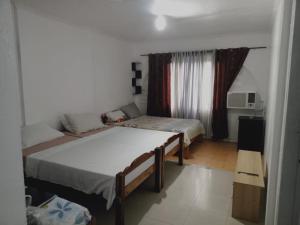 um quarto com 2 camas e uma janela em SEASCAPE em Moalboal