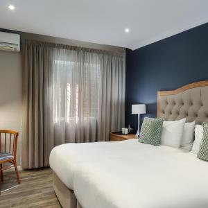 a bedroom with a large bed and a window at Premier Express Inn George in George