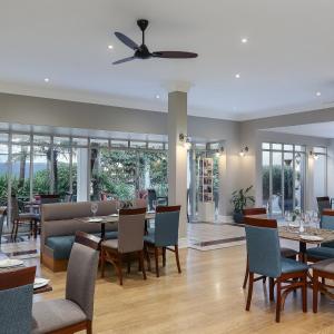 a dining room with a table and chairs at Premier Express Inn George in George