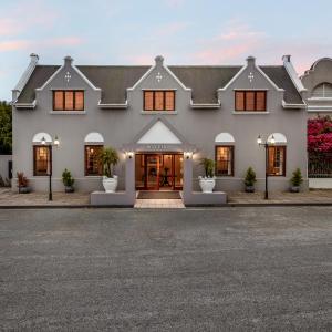 a white house with a driveway in front of it at Premier Express Inn George in George