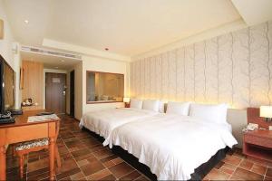 Letto o letti in una camera di Kenting Moli Bay Seaview Resort Hotel