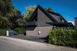 a small house with a gambrel roof at Wellness House Auszeit in Timmendorfer Strand