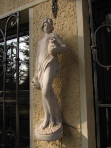 a statue of a woman on the side of a building at Apartamentai Lampėdžiuose in Kaunas