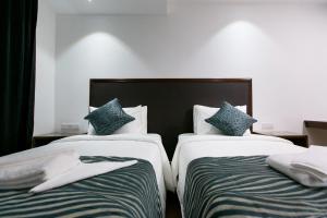 Voodi või voodid majutusasutuse Belllo Hotel JB Central toas