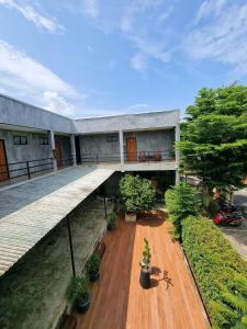 an external view of a building with trees and plants at Come Moon Loft Hotel in Phrae