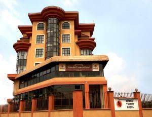 a tall yellow building with a gambrel at Nairobi Transit Hotel in Nairobi