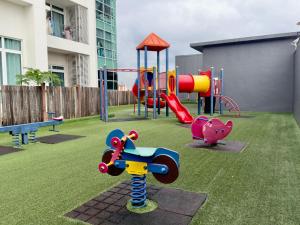 a playground with a slide and a swing at JB City Shopping Mall Apartment in Johor Bahru