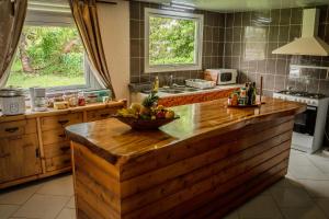 a kitchen with a bowl of fruit on a counter at Havae Lodge in Teahupoo