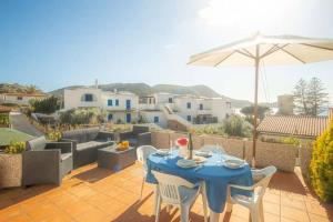 a blue table with chairs and an umbrella on a patio at Isolella in Campese