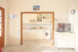 a kitchen with a sink and a washing machine at Isolella in Campese +1 photo