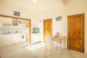 a kitchen with a table and a dining room at Isolella in Campese