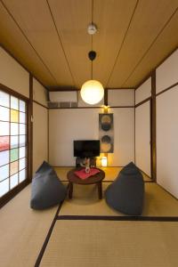 a room with two pillows and a table in a room at 【天神HOUSE 】一軒家まるまる貸切 in Fukuoka