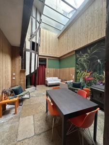 a living room with a table and chairs at Chambre dans maison originale en centre ville in Troyes