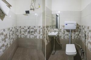 a bathroom with a shower and a toilet and a sink at FabHotel Prince Mama in Gwalior