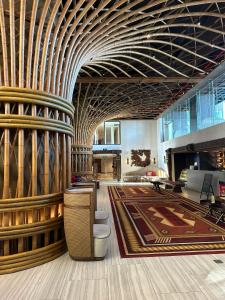 a lobby with a large room with wooden columns at QUEEN APEC MANDALA PHÚ YÊN in Tuy Hoa