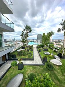 a view of a garden on a building with a swimming pool at Millennium Tower in Pattaya South