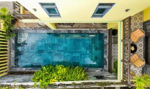 a swimming pool in the middle of a house at Villa Soleil Hoi An in Hoi An