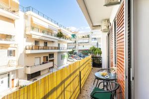 a balcony with a table and some buildings at Sofi's Flat in the city center, 5min to the sea in Kalamata