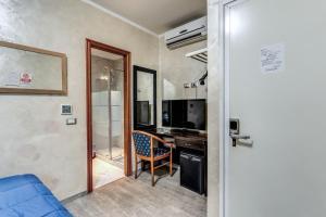 a room with a desk with a computer and a chair at Hotel Family House in Rome +33 photos