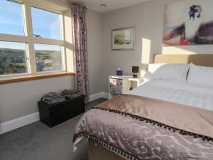 a bedroom with a large bed and a window at New Heights in Keighley