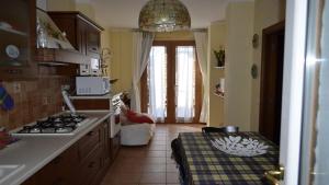 a kitchen with a sink and a stove at Rinaldi's Apartment in Sirolo