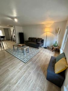 a living room with a couch and a table at Appartement hyper centre in Rodez