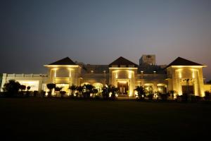 a large building with lights on it at night at Enrise by Sayaji Rewa in Rewa