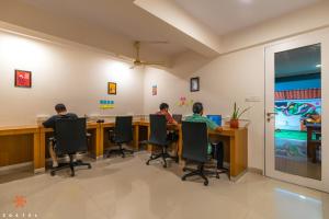 two people sitting at a table in an office at Zostel Bangalore (Koramangala) in Bangalore