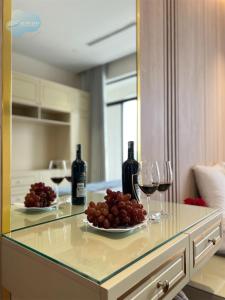 two glasses of wine and a plate of grapes on a counter at Thanh Ha Villa in Ha Long