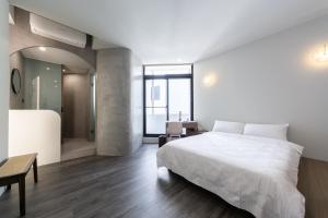 Postel nebo postele na pokoji v ubytování Yu Tainan BnB