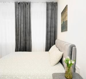 a bedroom with a bed and a couch at Central Station Apartment No3 in Kaunas