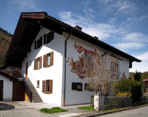 a white building with a mural on the side of it at FeWo Viola 1 OG in Mittenwald
