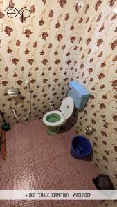 a bathroom with a blue toilet in a room at HostelExp, Gokarna - A Slow-Paced Backpackers Community in Gokarna