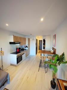 a living room with a kitchen and a dining room at Studio cabine vue port in Le Grau-du-Roi +5 photos