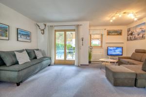 a living room with a couch and a table at Haus Kemp in Zell am See
