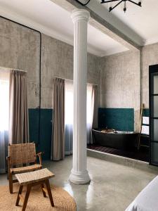 a room with a column and a bath tub at Sundays Boutique Eco Hotel in Phnom Penh